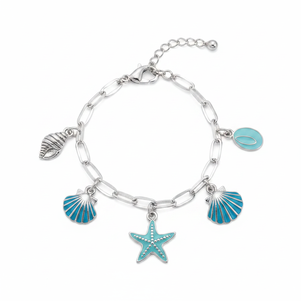 Ocean seashell charm station bracelet in silver-tone, Conch & Nautilus style — silver paperclip link chain with lobster claw clasp and ball extender, 5 dangling charms: silver conch shell, teal enamel scallop shell, teal enamel starfish, teal enamel scallop shell, and small teal oval disc, white background
